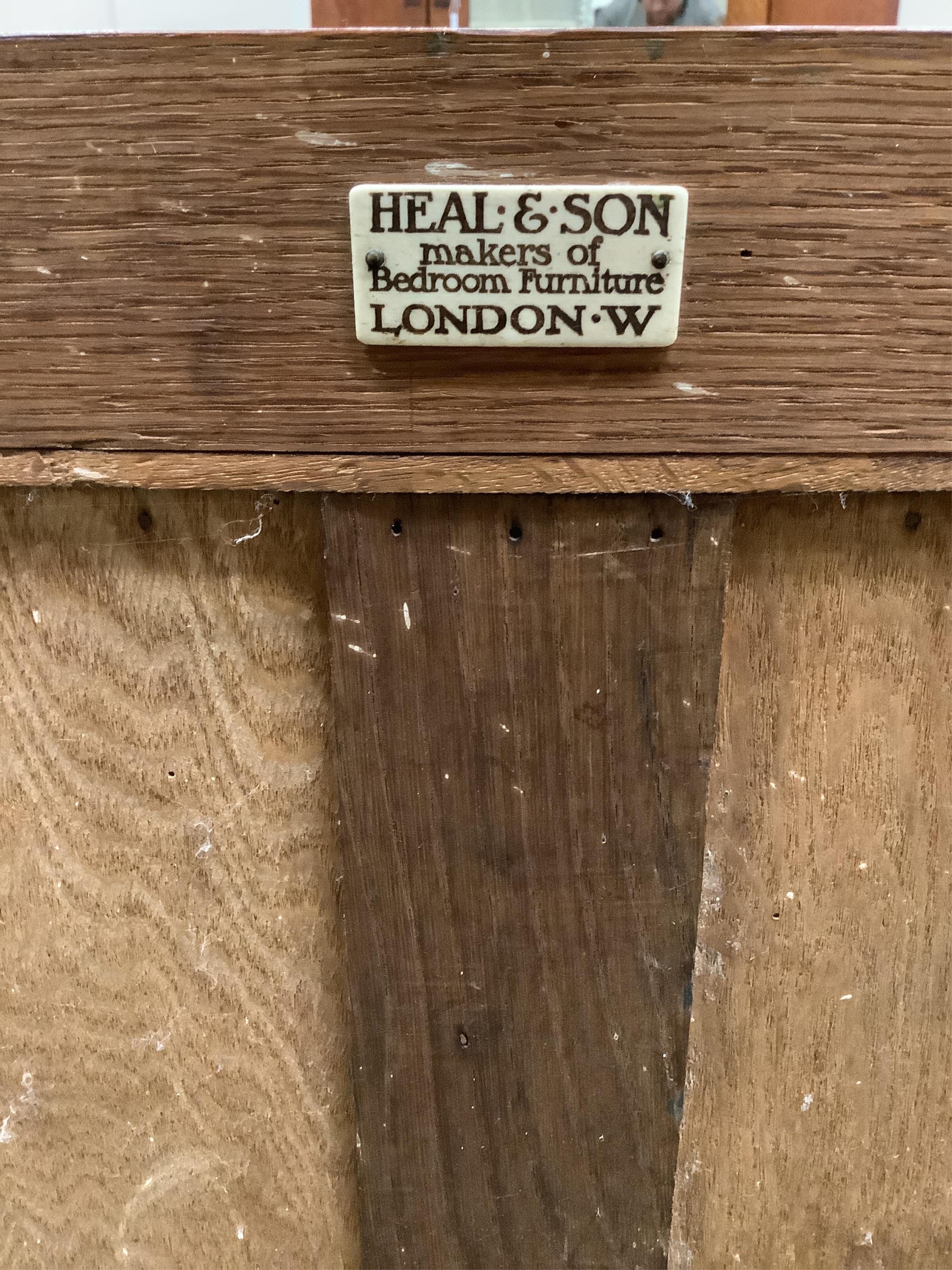 Heal & Son Ltd. A plain oak '507 Cottage Furniture' dresser with curtains, c.1906, width 122cm, depth 46cm, height 104cm. Condition - good